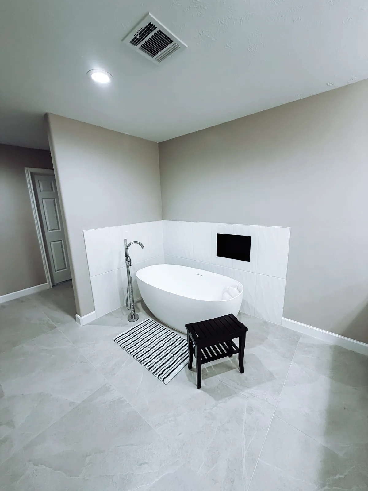Freestanding soaking tub in a spa-like Manvel, TX bathroom remodel by Texan Home Additions